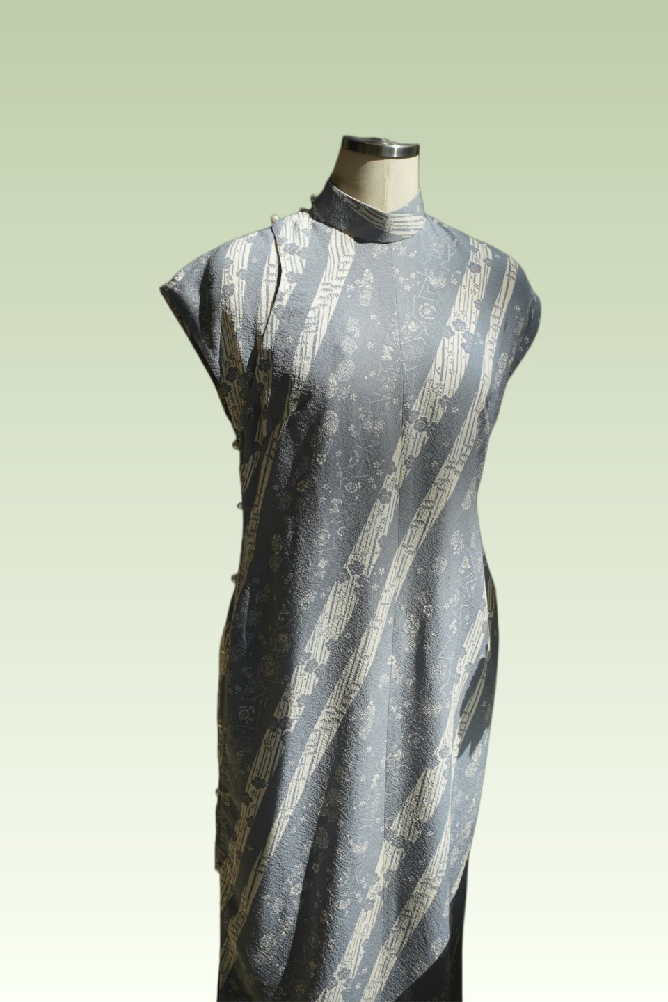 Silver patterned Qipao detail on a dress form