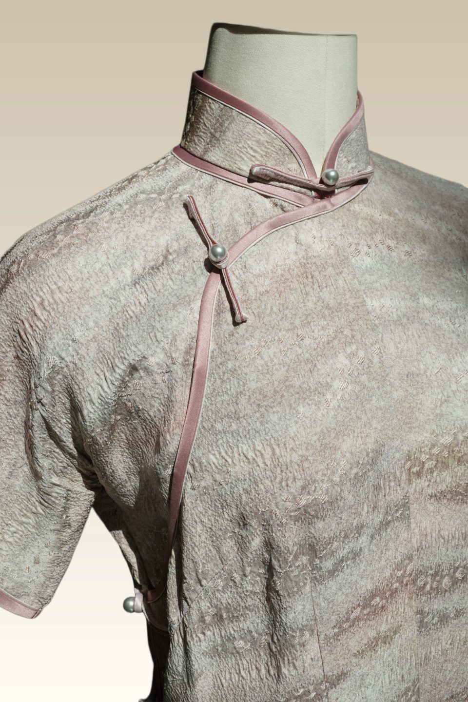 Blush ceramic-hued Qipao with tailored three-quarter length sleeves, rose piping and grey pearl bicolor frog buttons